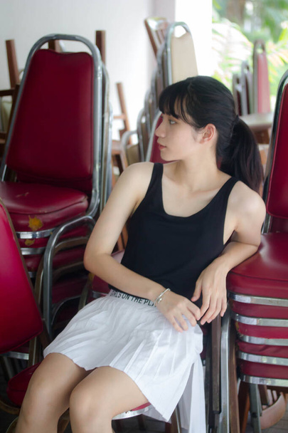 Portrait von thai adult beautiful girl black shirt white rock relax time - Foto, Bild
