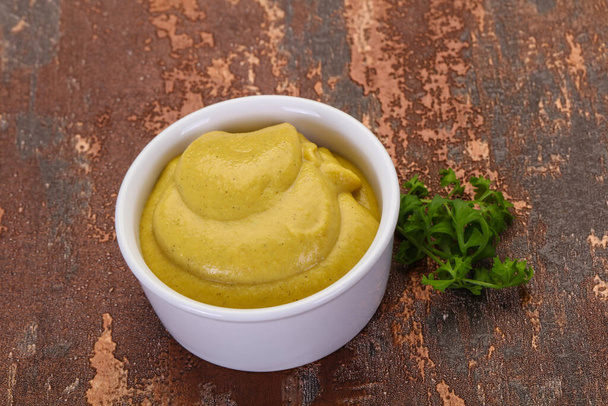 Mustard sauce in the bowl served parsley - Фото, зображення