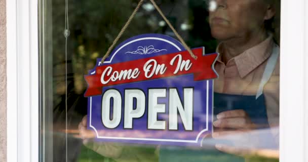 4k Unhappy Female Shop Owner Flips Open Sign To Closed Amidst Coronavirus Pandemic - Felvétel, videó