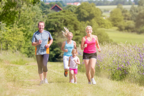 Family sport running through field - Photo, Image