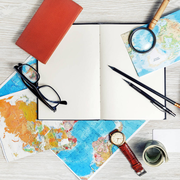 Making travel plan. Map, blank book, magnifier, glasses, notebook, pencils, clock and money. Top view. Flat lay. - Foto, Imagem