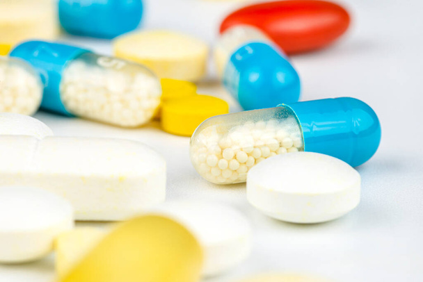 Background made of different kinds of colorful pills and tablets, macro shot. - Photo, Image