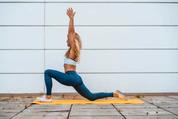 fit blonde woman doing yoga  - 写真・画像