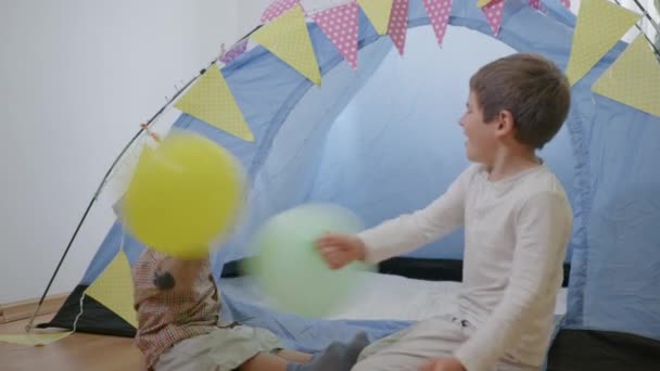 happy childhood, attractive cheerful children boys play fun with balloons - Footage, Video