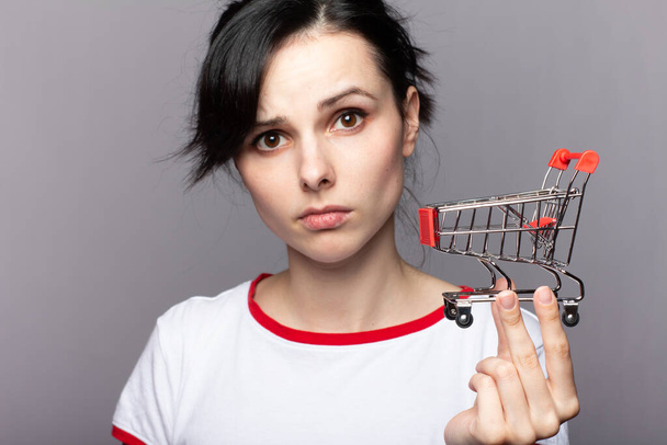 woman holding a small trolley from a store - Photo, Image