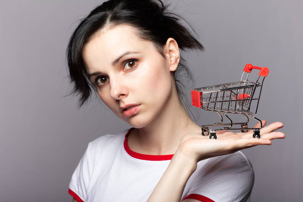 woman holding a small trolley from a store - Photo, Image