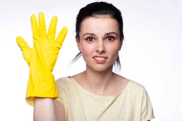smiling woman in yellow cleaning gloves, white background - Fotografie, Obrázek