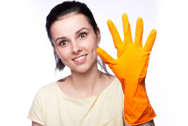 emotional woman in orange cleaning gloves, cleaning company employee - Fotoğraf, Görsel