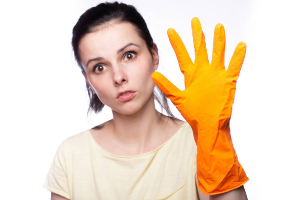 emotional woman in orange cleaning gloves, cleaning company employee - Foto, Imagem