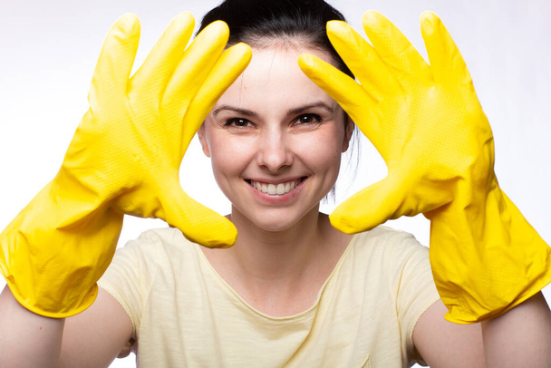 smiling woman in yellow cleaning gloves, white background - Fotografie, Obrázek
