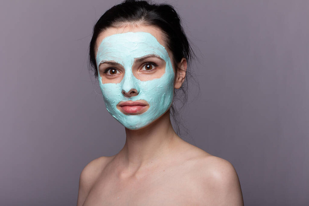 woman in  cosmetic mask , problem skin, gray background - Fotografie, Obrázek