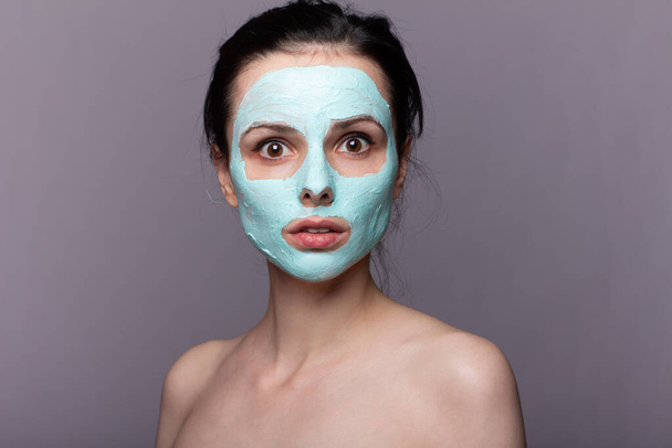 woman in  cosmetic mask , problem skin, gray background - 写真・画像