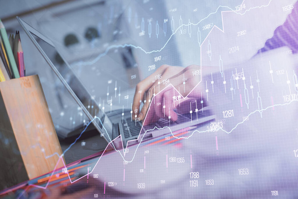Double exposure of woman hands typing on computer and forex chart hologram drawing. Stock market invest concept. - 写真・画像