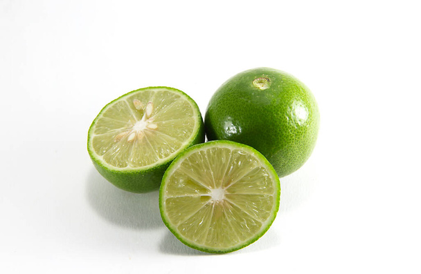 Thai lemons are placed in front of the fruit cluster and separated from a white background. - Valokuva, kuva