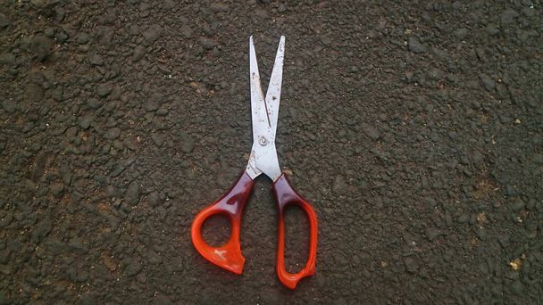 scissors lying on cracked asphalt - Photo, Image
