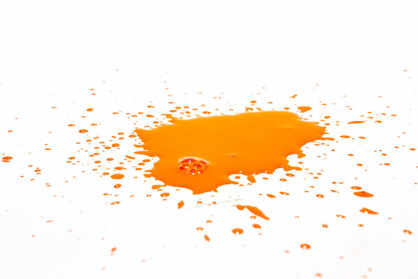 Orange water droplets splashing on a white background - 写真・画像