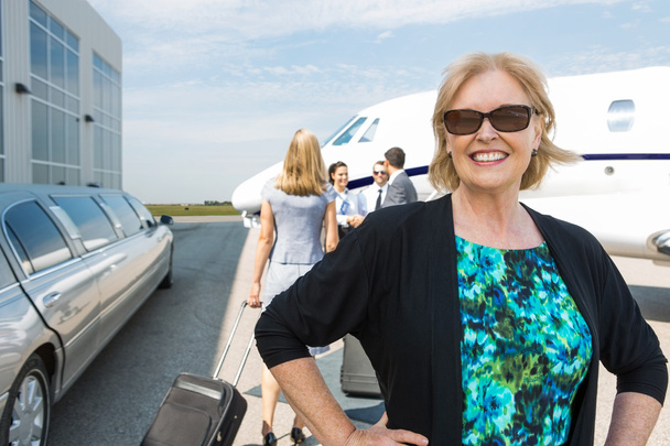 Happy Businesswoman Against Private Jet - Fotó, kép