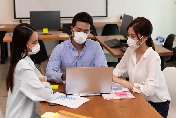 Asian business man and women talk about job and wear masks.New nomal - Photo, Image