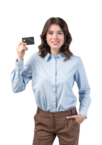 Isolated portrait of smiling young businesswoman with dark hair holding credit card. Concept of online banking and e commerce - Photo, image