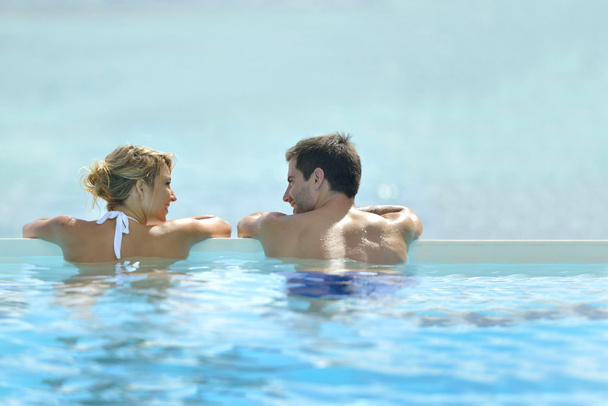 Couple swimming in infinity pool - Photo, Image