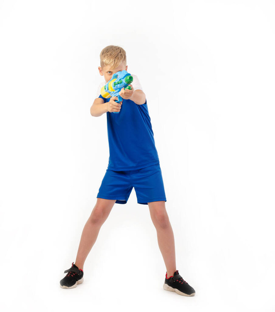 boy with water pistol on white background - Фото, изображение