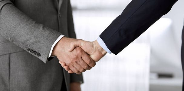 Business people in office suits standing and shaking hands, close-up. Business communication concept. Handshake and marketing - Fotoğraf, Görsel