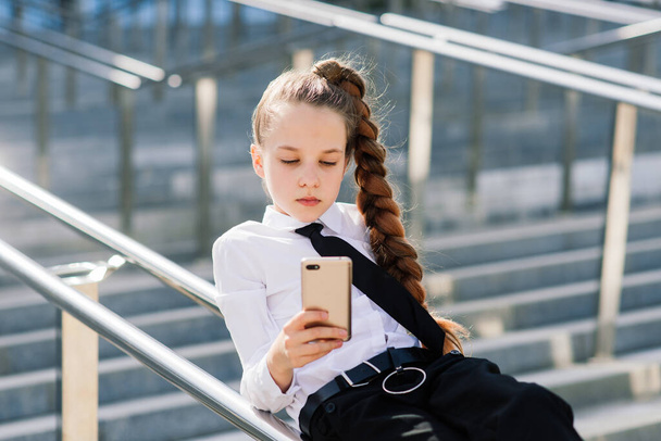 Little school girl having phone talk with friend. Modern life. Living in digital age. - Foto, imagen