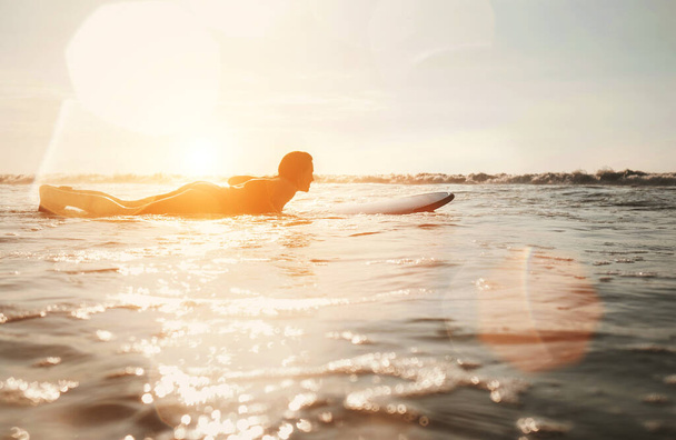 Woman surfer floating on the long surfboard towards line up - Фото, зображення