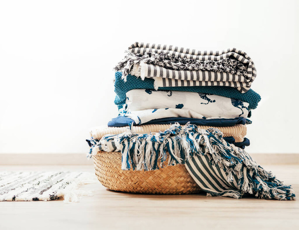 Basket with blue and beige laundry - Fotoğraf, Görsel