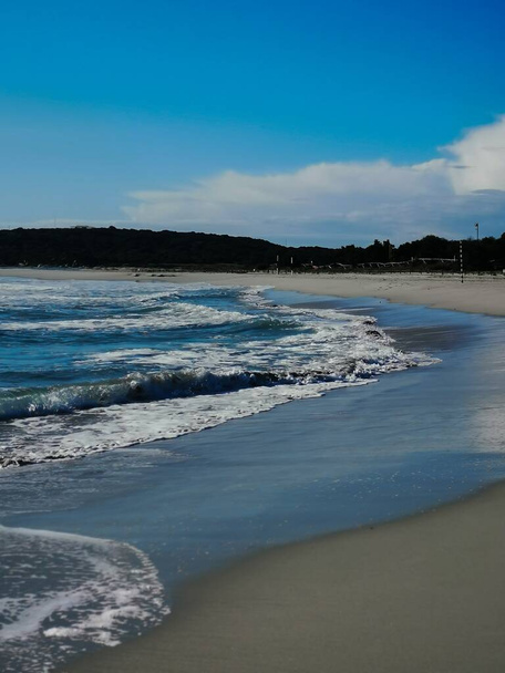 A beautiful shot of a sandy beach and small waves of the sea - Foto, immagini