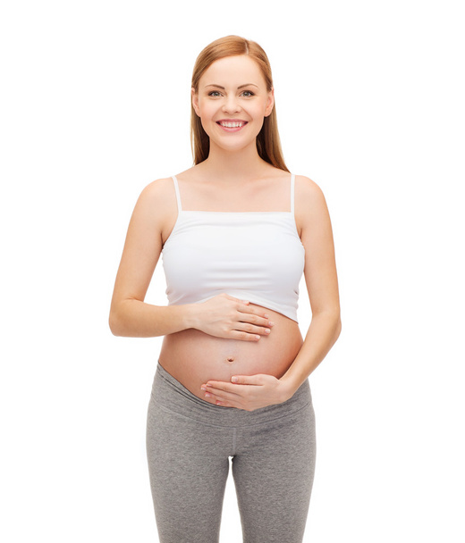 Happy future mother touching her belly - Foto, Bild