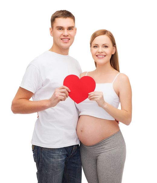Happy young family expecting child with big heart - Fotografie, Obrázek