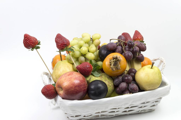 Wicker basket full of colorful  freshly picked organic fruits - 写真・画像