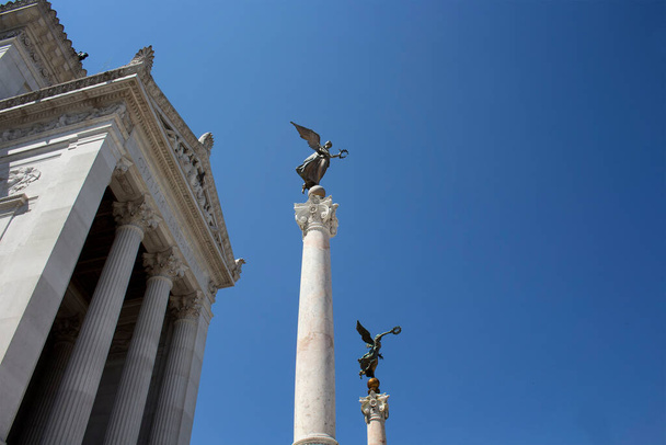 View of winged woman statues at Altar of the Fatherland in Rome. Grand marble, classical temple honoring Italy's first king & First World War soldiers. - Zdjęcie, obraz