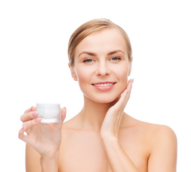Woman applying cream on her skin - Foto, immagini