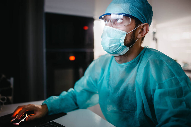plastic surgeon doctor examines medical data on a computer after surgery - Photo, image