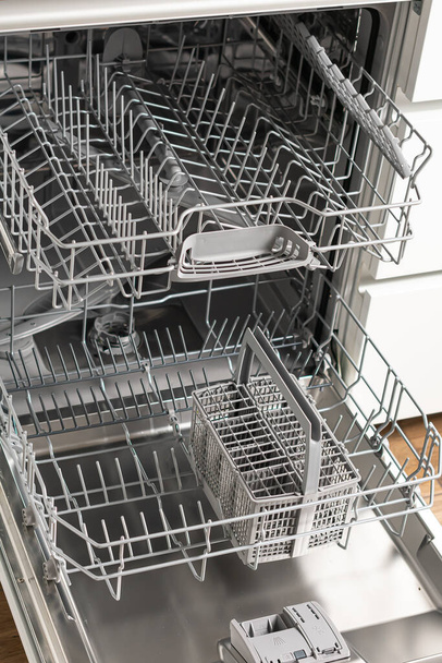 high angle view of open dishwasher with plates in modern kitchen - Photo, Image