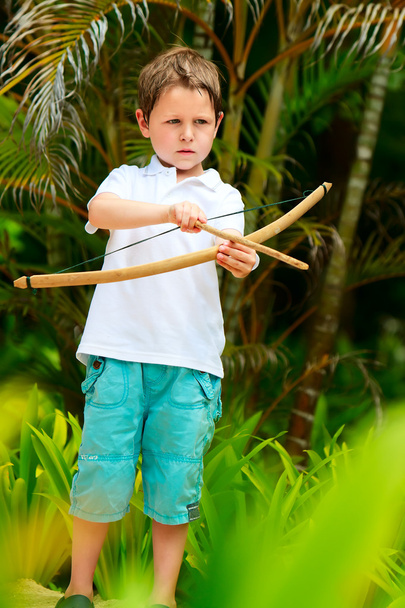Cute boy playing with bow and arrows - Фото, зображення