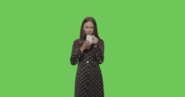 Pretty smiling girl drinking coffee - Filmati, video