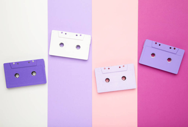Old colorful cassettes on a colorful background. Music day, top view - Photo, Image