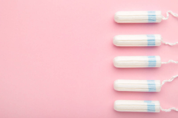Menstrual tampons on a pink background. Menstruation cycle. Hygiene and protection. - Photo, Image
