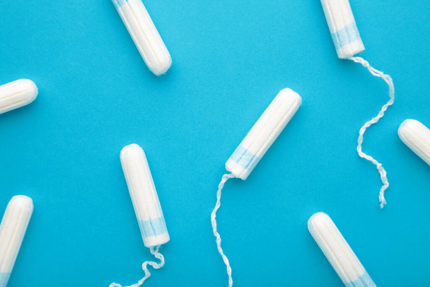 Menstrual tampons on a blue background. Cotton tampon for women. Top view - Photo, Image