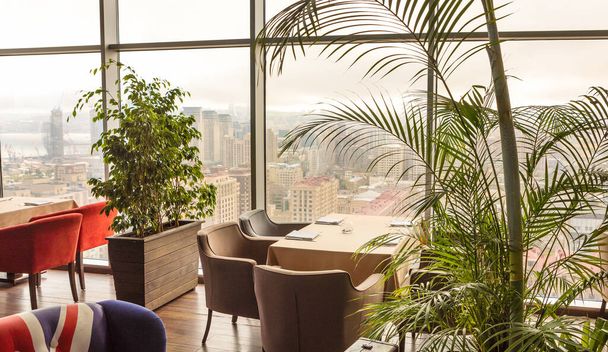 Beautiful restaurant interior with plants, city view - Photo, Image