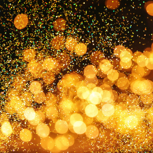 Luxury golden glitters on dark background. Bokeh effect  - Zdjęcie, obraz