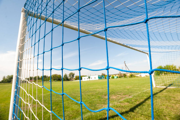 Football gate and football net. Soccer concept. Village stadium. - Фото, изображение