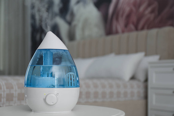 Modern air humidifier on table indoors. Space for text - Zdjęcie, obraz