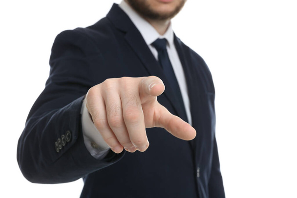 Businessman touching something against white background, focus on hand - 写真・画像
