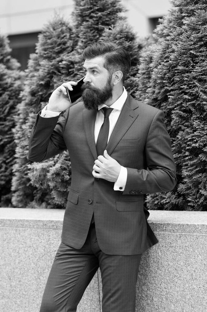 Another client. successful insurance agent. your future employer. handsome manager use smartphone. man in formal outfit outside. realtor button jacket. modern life concept. portrait of confidence - Фото, изображение