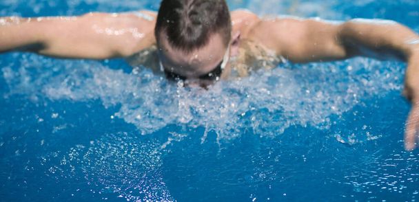 Male swimmer at the swimming pool. Underwater photo. Male swimmer. - Fotografie, Obrázek