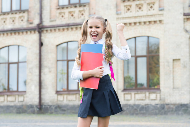 Childrens Future. concept of education and reading. development of imagination. cute girl hold notebook. happy preschool girl in school yard. back to school. hardworking child carry backpack - Valokuva, kuva